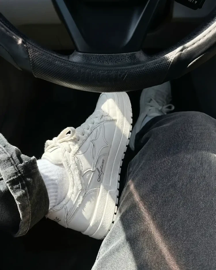 Creme Broken Denim sneakers in the car