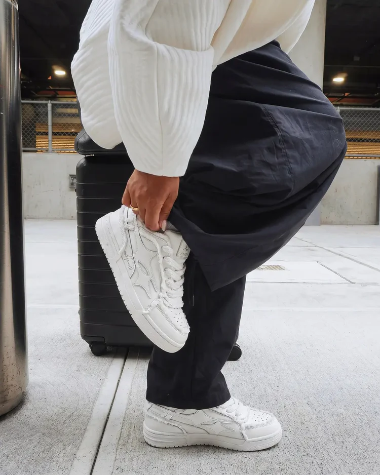 Creme sneakers at the airport